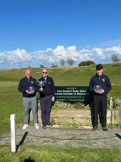 Winning players Paul Caldicott (left), Harrison Sewell (right) and Northumberland Golf Club Captain - Gordon Brown (middle)
